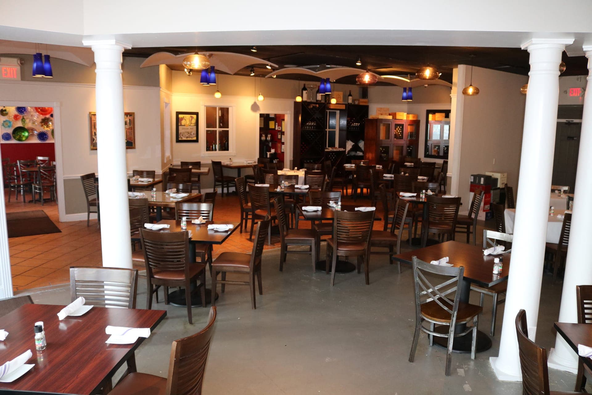 Brandani's Restaurant interior with columns, paintings on walls, and wine storage